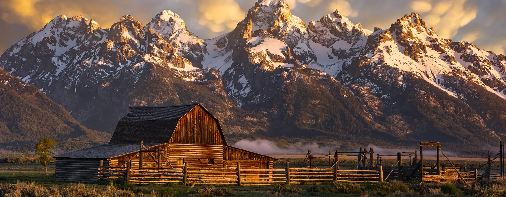A rustic ranch with mountains in the distance