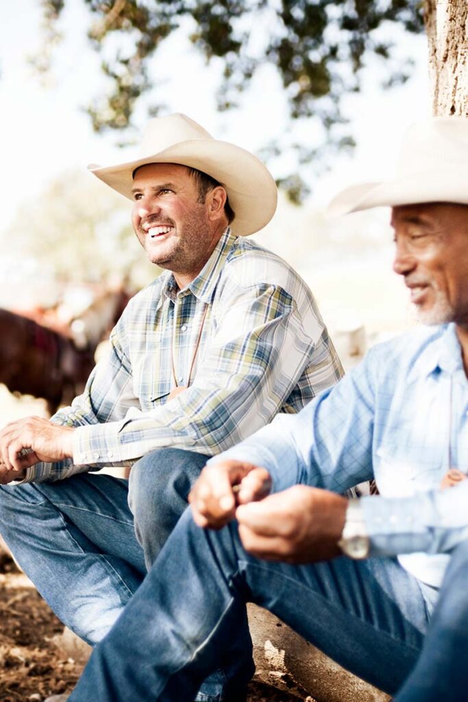 two happy ranchers talking